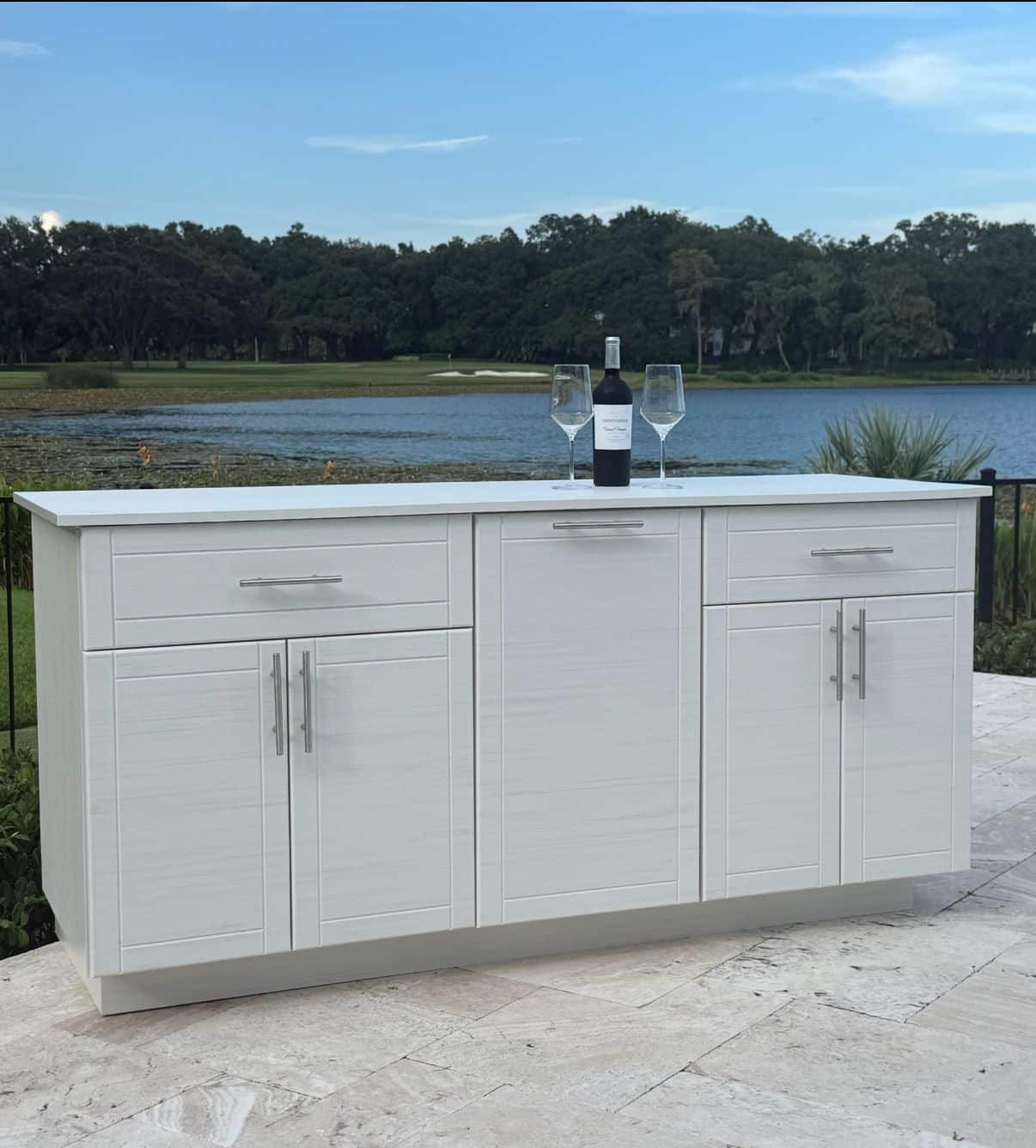 Completed outdoor kitchen island with polymer cabinets installed on a Central Florida patio