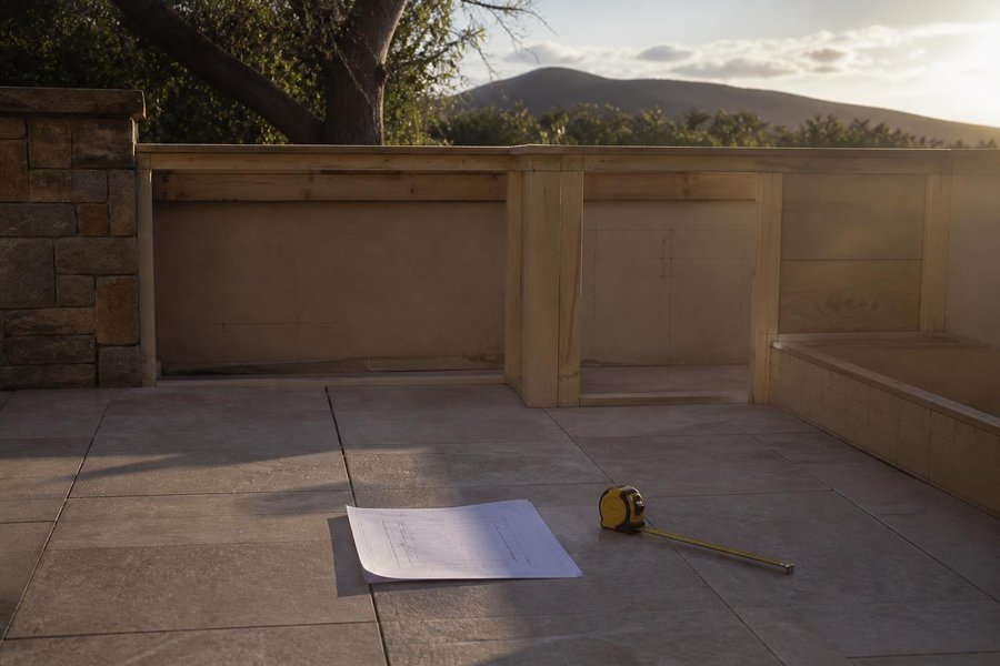 How the Custom Design Process Works for an Outdoor Kitchen Cabinet Build: Tape Measure and Plan at a Framed Footprint