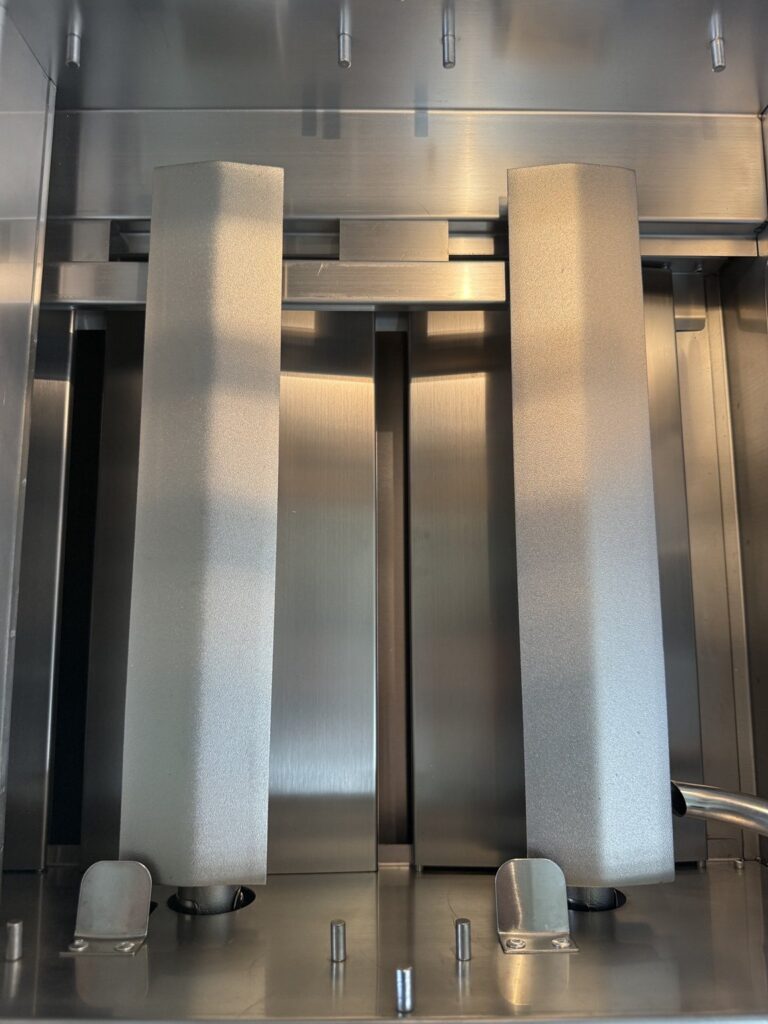 Cast stainless steel burners and flame tamers inside a built-in gas grill